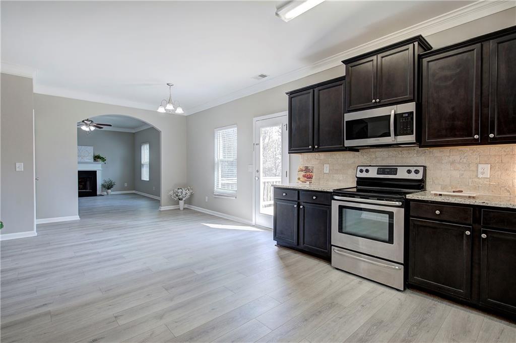 4 Timberland Trace Court Dallas, GA 30157 - Photo 10 of 53 a kitchen with stainless steel appliances kitchen island granite countertop a stove and cabinets