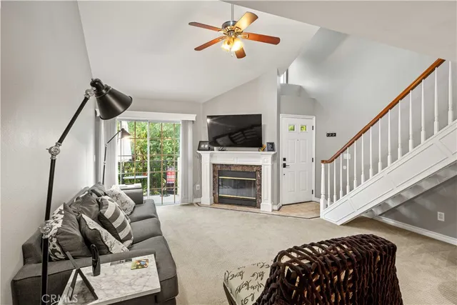 a living room with furniture a fireplace and a flat screen tv