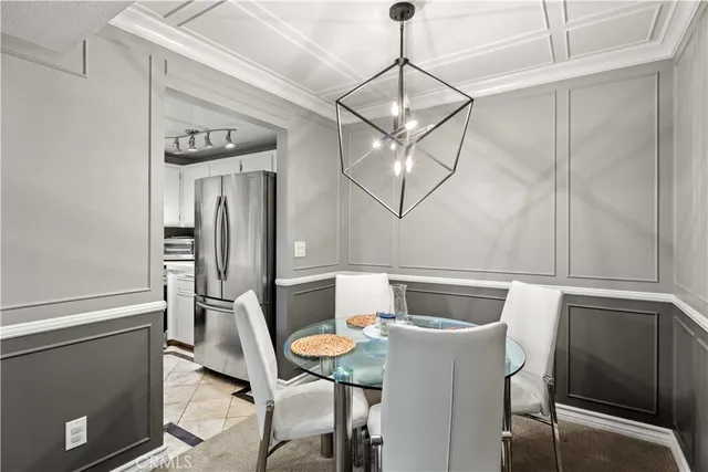 a view of a dining room with furniture and chandelier