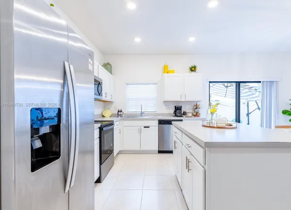 a kitchen with a sink cabinets and stainless steel appliances