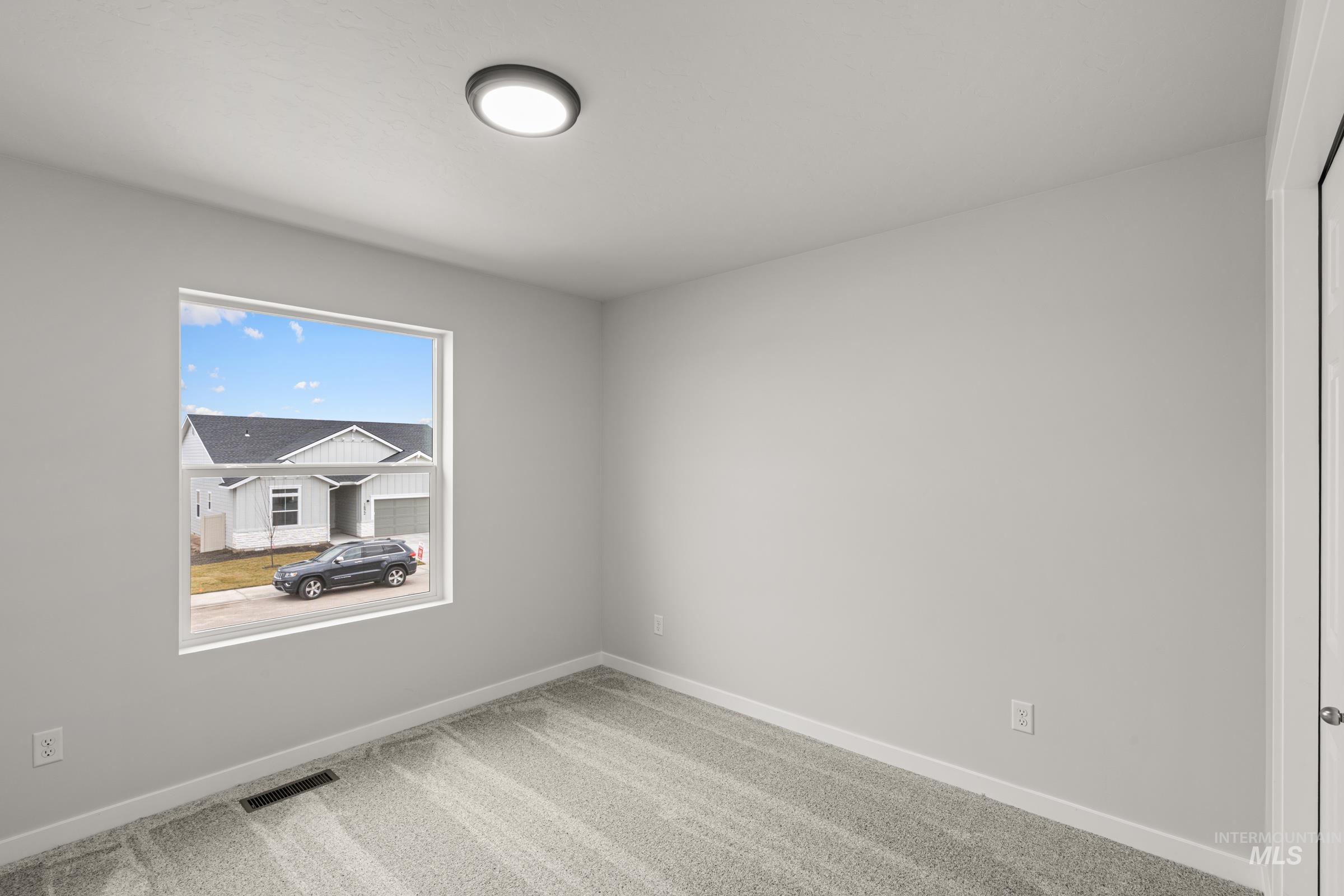 13693 Redway Court Caldwell, ID 83607 - Photo 16 of 25 Empty room featuring light carpet and baseboards