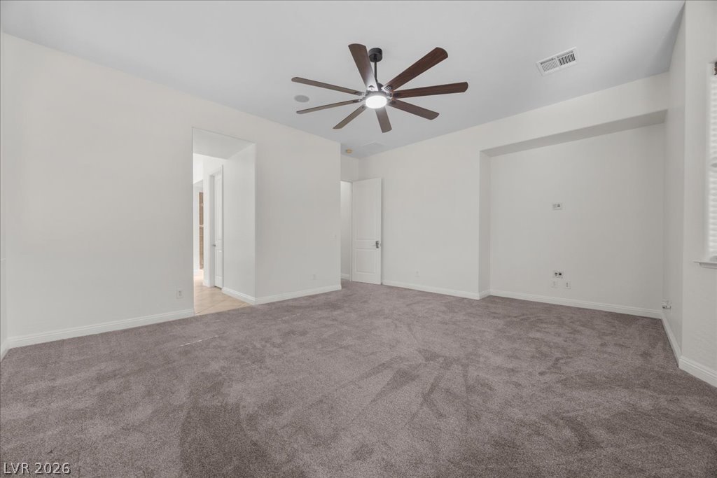 2125 De Rouge Avenue Henderson, NV 89044 - Photo 45 of 96 A quiet retreat with a dark ceiling fan and plush gray carpeting.