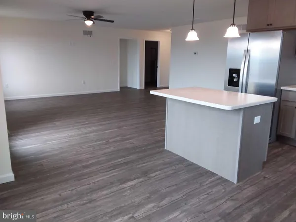 a large kitchen with hardwood floor and a sink