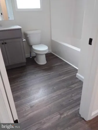 a white toilet sitting next to a bathroom sink