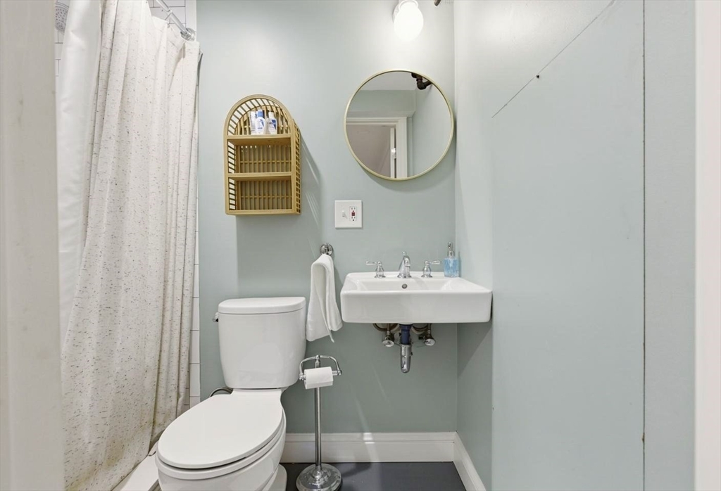 38 Bartlett Street Boston, MA 02129 - Photo 32 of 37 a bathroom with a toilet a sink and mirror
