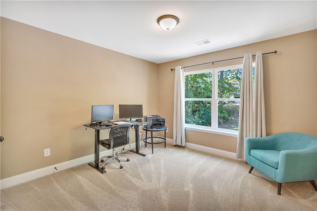 3004 Cobbs Way Anderson, SC 29621 - Photo 23 of 46 A spacious home office setup showcases soft carpeting and a wide window viewing local greenery.
