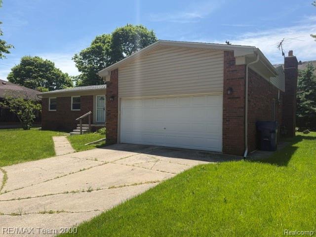 580 Palmerston Street River Rouge, MI 48218 - Photo 2 of 19 Brick and siding exterior featuring an attached two-car garage, a concrete driveway, and a front entry with steps