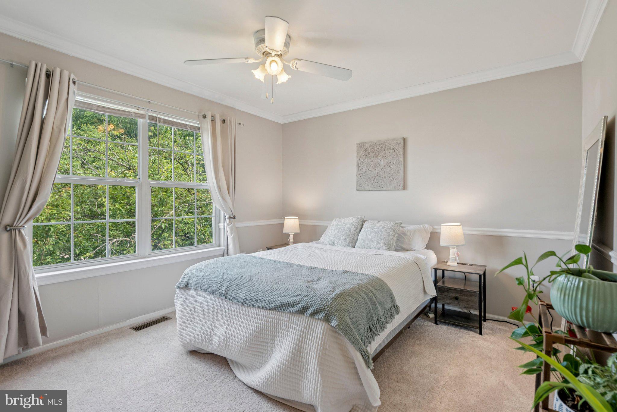 3559 Orchard Shade Road Randallstown, MD 21133 - Photo 11 of 18 a spacious bedroom with a bed and a chandelier