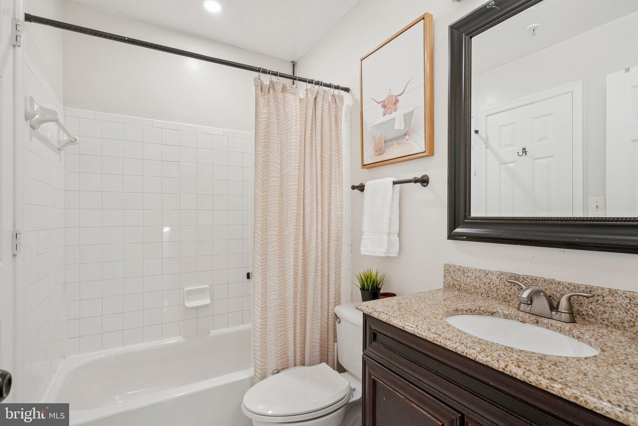 3559 Orchard Shade Road Randallstown, MD 21133 - Photo 12 of 18 a bathroom with a granite countertop sink toilet and shower