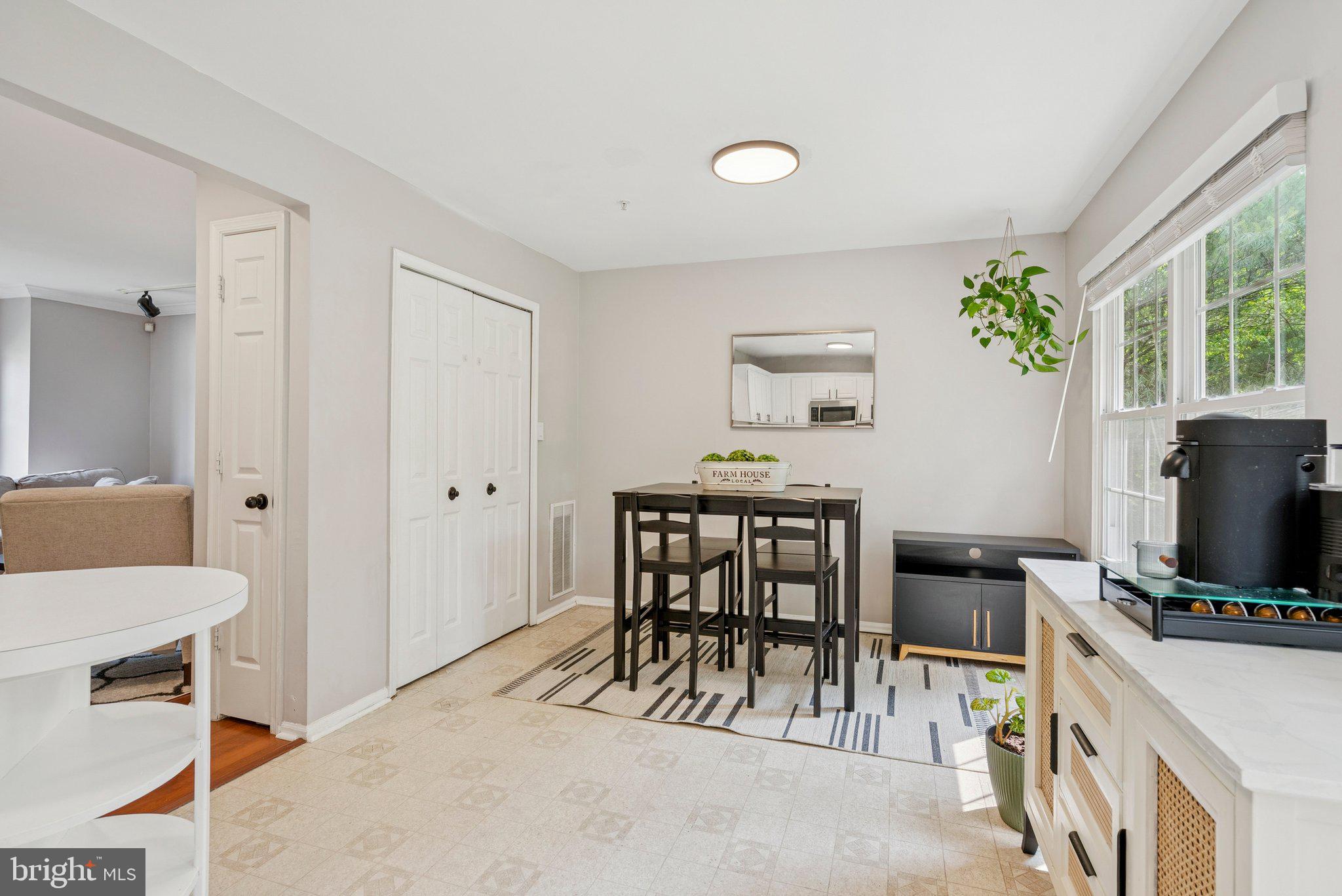 3559 Orchard Shade Road Randallstown, MD 21133 - Photo 6 of 18 a view of a livingroom with furniture a flat screen tv and a window
