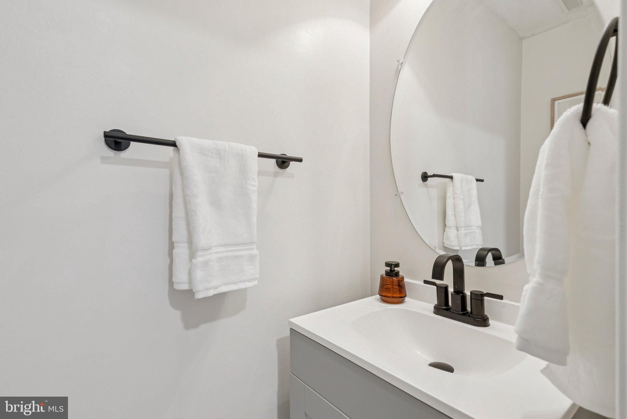 3559 Orchard Shade Road Randallstown, MD 21133 - Photo 8 of 18 a bathroom with a sink and mirror