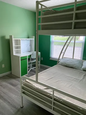a view of room with window and wooden floor