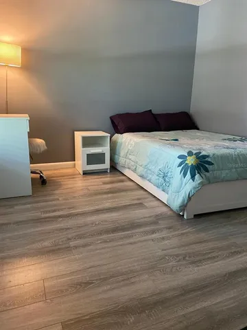 a bedroom with a bed and a couch