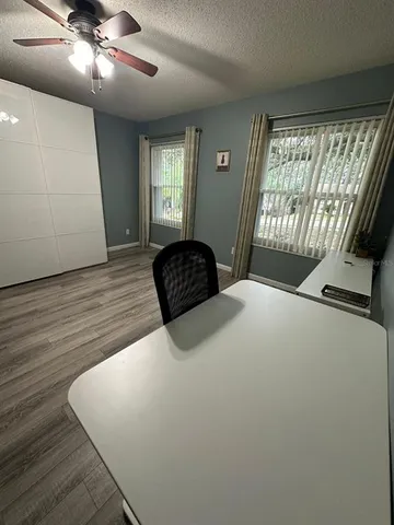 a view of a room with wooden floor and windows