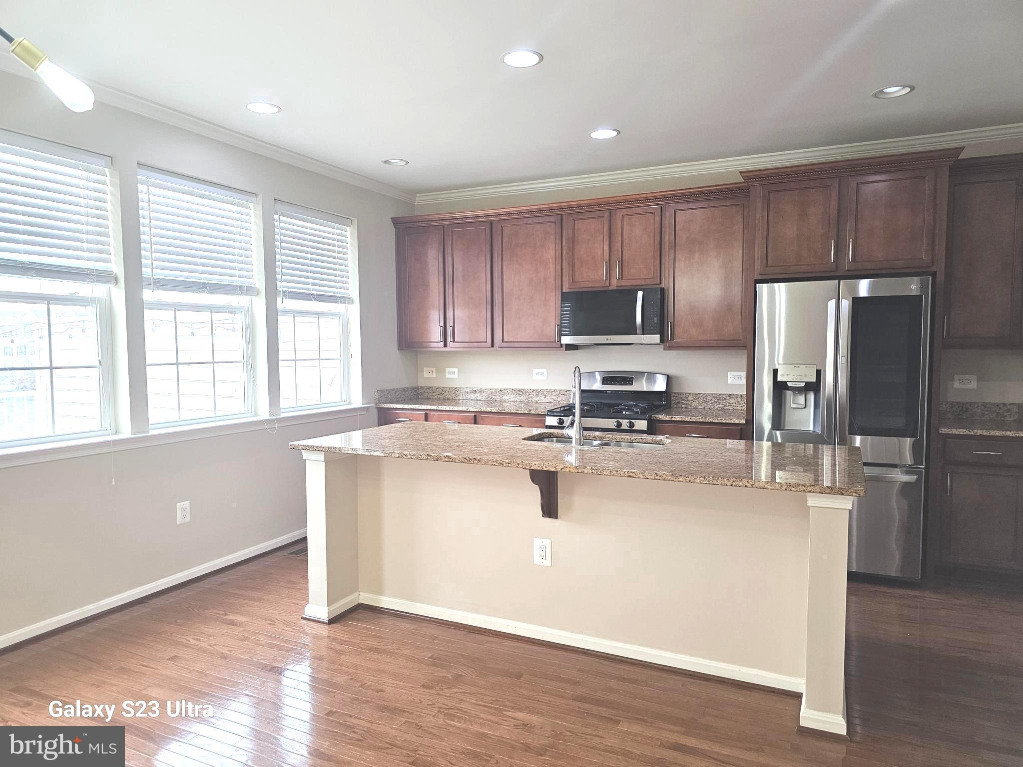 25634 Pleasant Valley Road Chantilly, VA 20152 - Photo 13 of 40 a kitchen with a refrigerator and a stove top oven