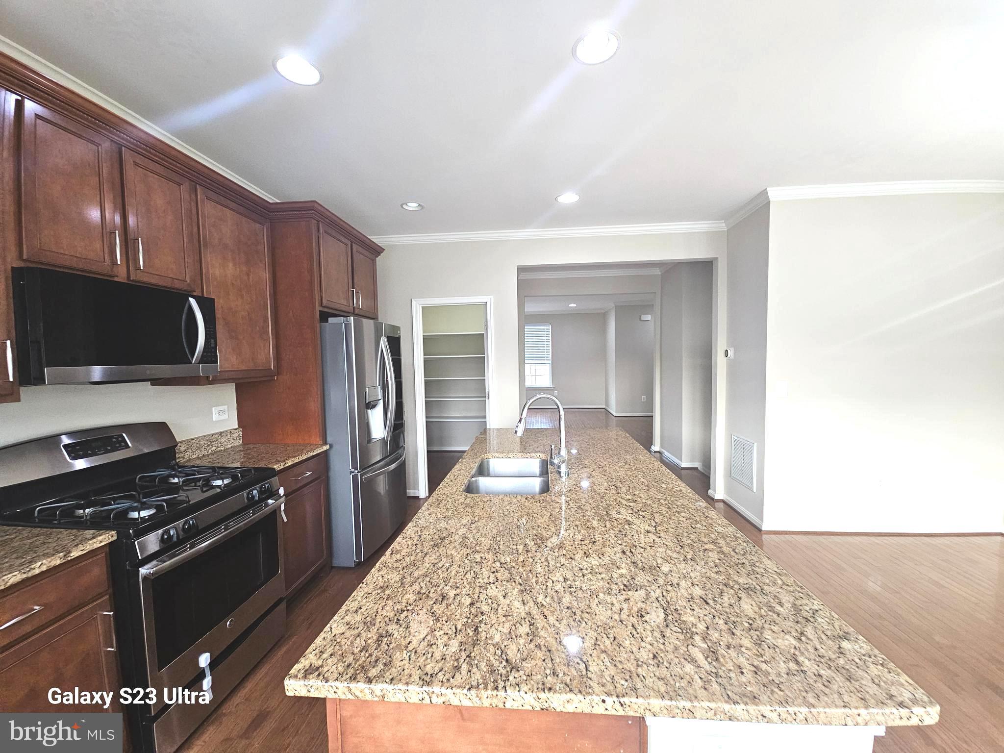 25634 Pleasant Valley Road Chantilly, VA 20152 - Photo 16 of 40 a kitchen with stainless steel appliances granite countertop a stove refrigerator and microwave