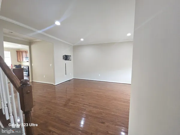 a view of hallway with wooden floor