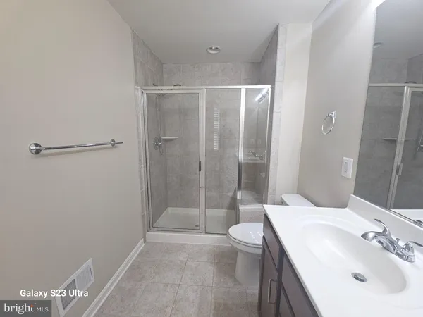 a bathroom with a sink mirror toilet and shower