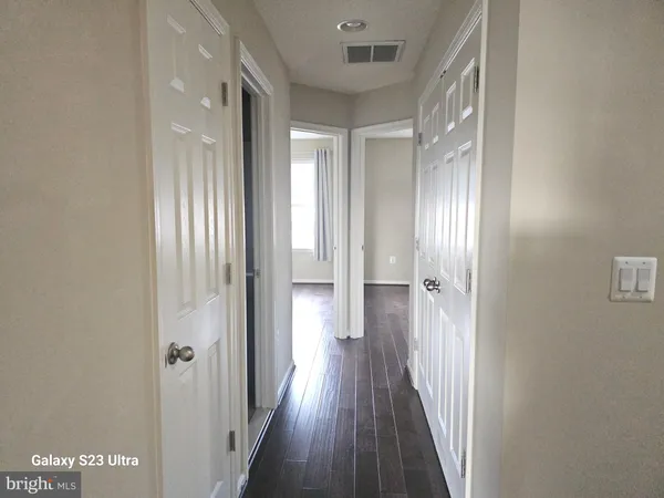 a view of a hallway with wooden floor