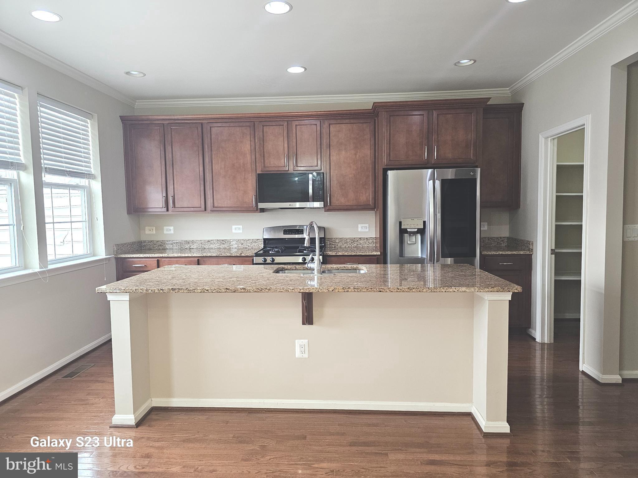 25634 Pleasant Valley Road Chantilly, VA 20152 - Photo 10 of 40 a kitchen with stainless steel appliances granite countertop a stove a sink a refrigerator a microwave and cabinets