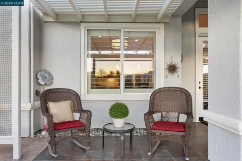 a view of a patio with dining table and chairs with wooden floor