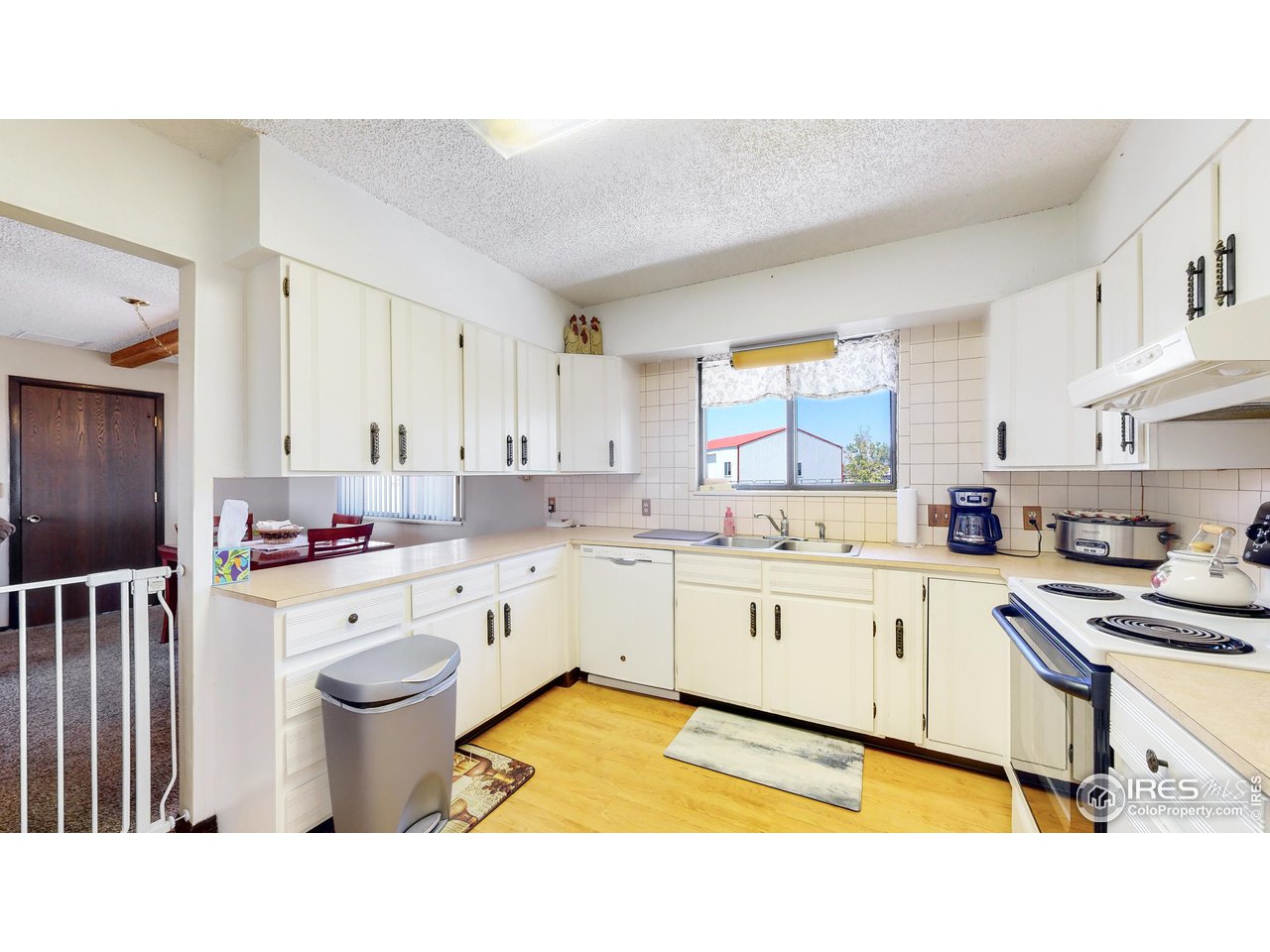 2812 Lake Hollow Road Berthoud, CO 80513 - Photo 11 of 39 a kitchen with a sink stove and cabinets