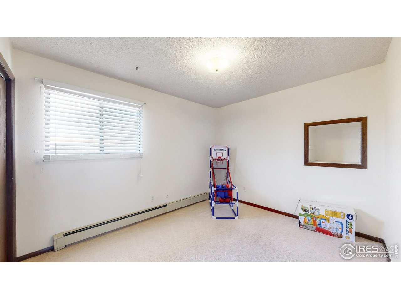 2812 Lake Hollow Road Berthoud, CO 80513 - Photo 22 of 39 a living room with a baby crib furniture and a window