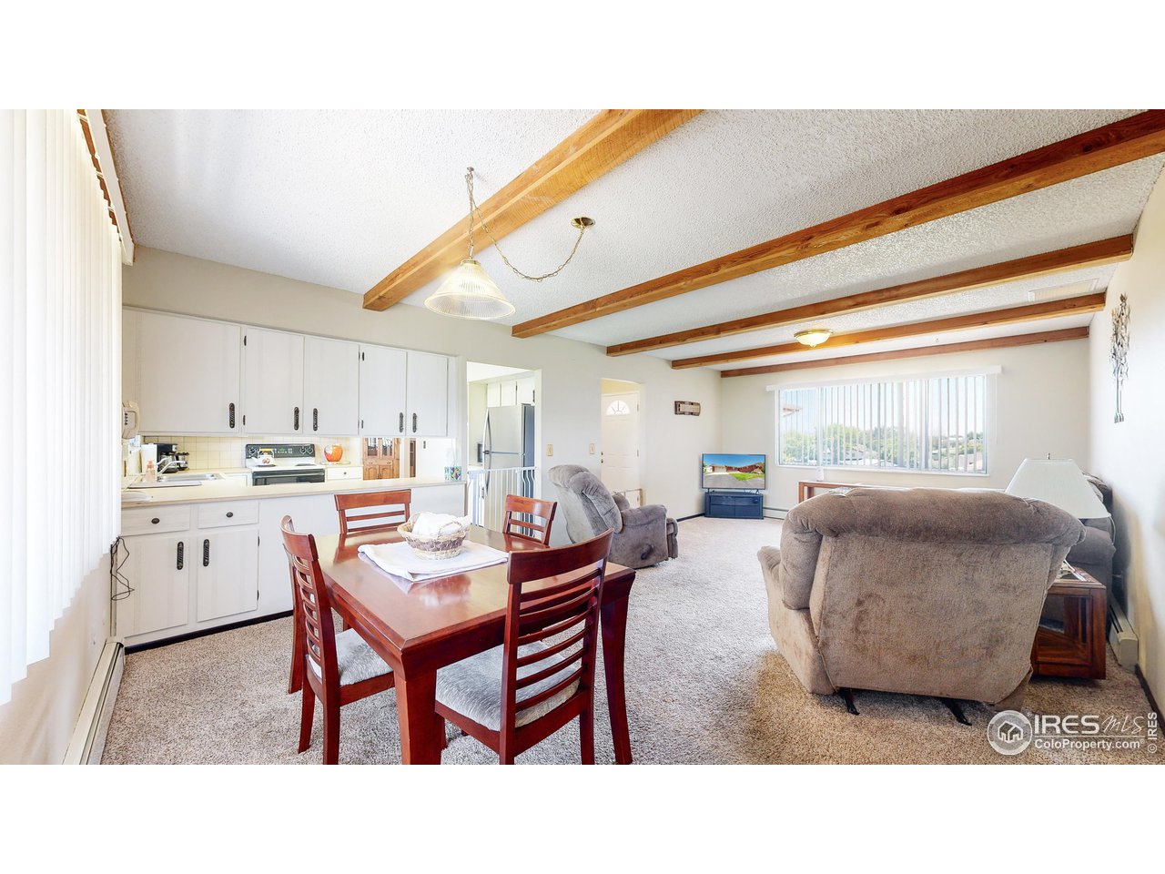 2812 Lake Hollow Road Berthoud, CO 80513 - Photo 8 of 39 a living room with kitchen island furniture and a table