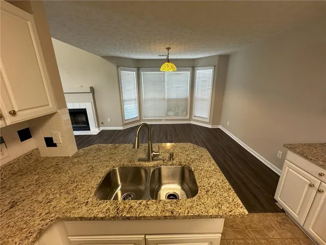 a kitchen with a stove a sink and a window