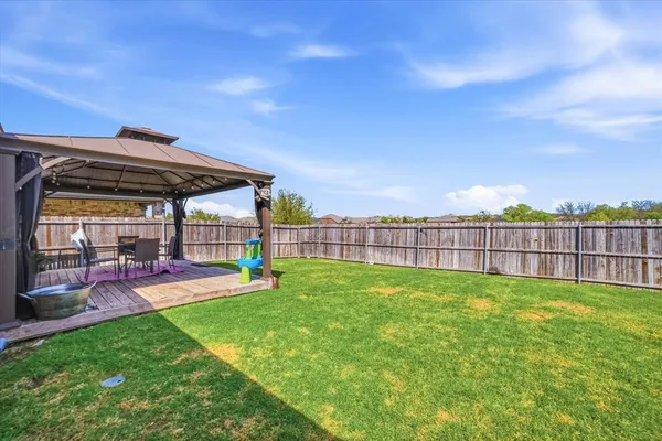a view of a backyard with sitting area