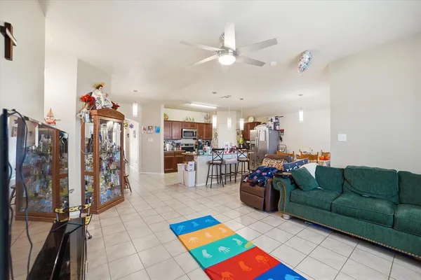 a living room with lots of furniture and kitchen view
