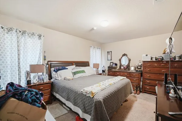 a bedroom with a bed and wooden furniture