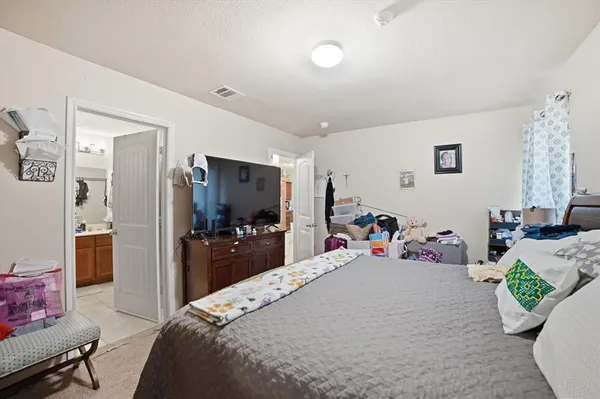a bedroom with bed and a tv