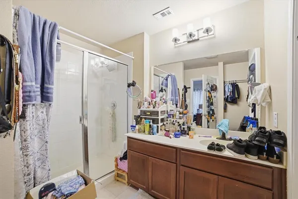a bathroom with double vanity and a mirror