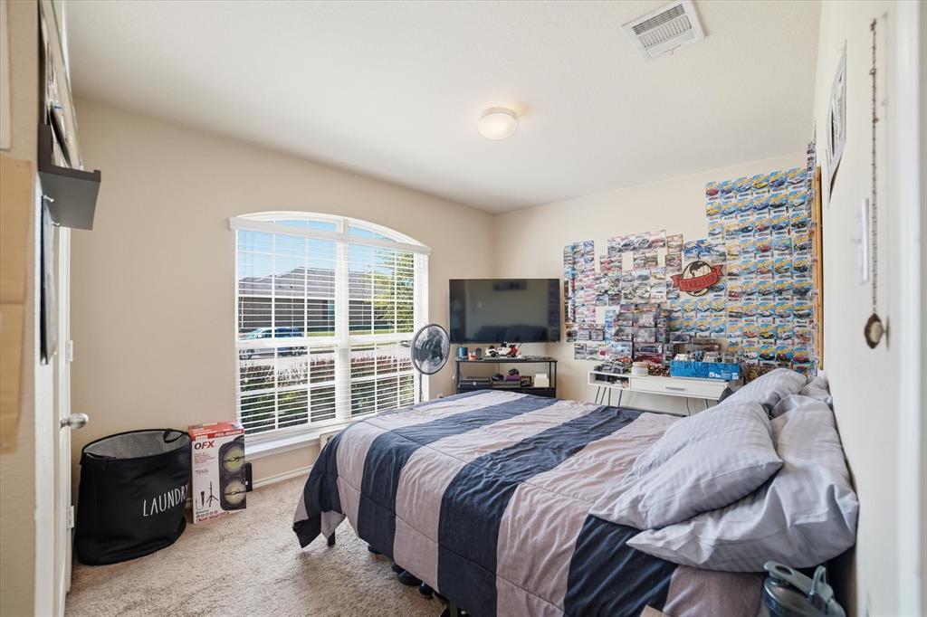 2126 Rubin Road Fate, TX 75189 - Photo 8 of 19 a bedroom with a bed and a television