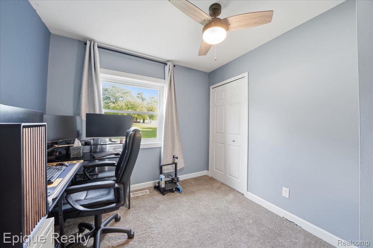 12272 East Mt Morris Road Davison, MI 48423 - Photo 15 of 39 Room featuring light blue walls, gray carpet, and a window with a green outdoor scenery