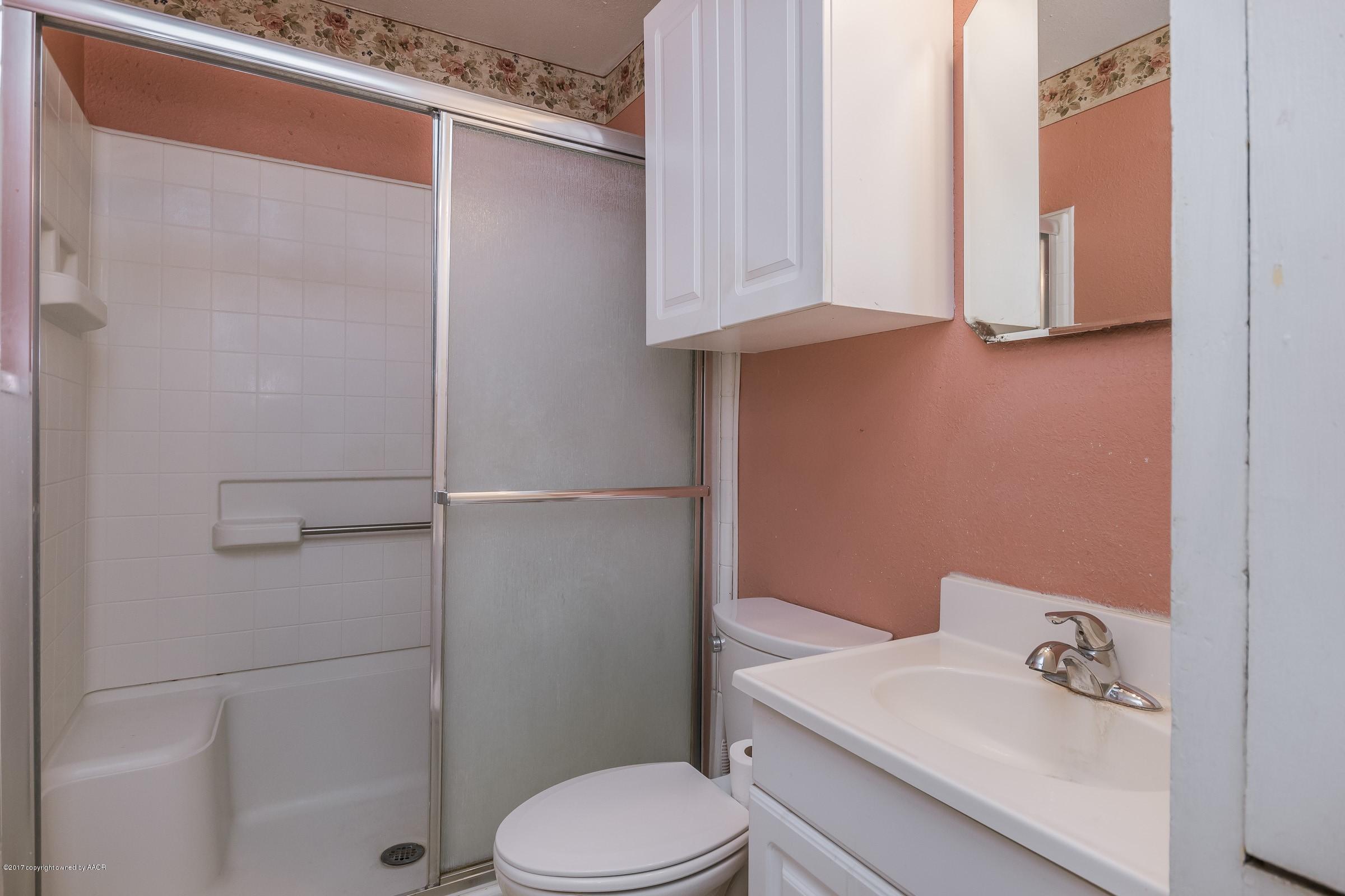 4220 South Harrison Street Amarillo, TX 79110 - Photo 11 of 15 a bathroom with a sink a toilet and shower
