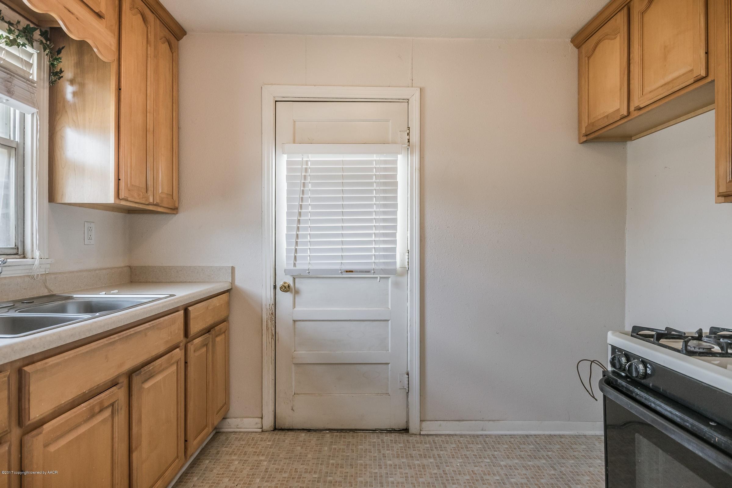 4220 South Harrison Street Amarillo, TX 79110 - Photo 8 of 15 a kitchen with stainless steel appliances granite countertop a sink and a stove top oven