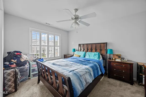 a bedroom with a bed and a chandelier