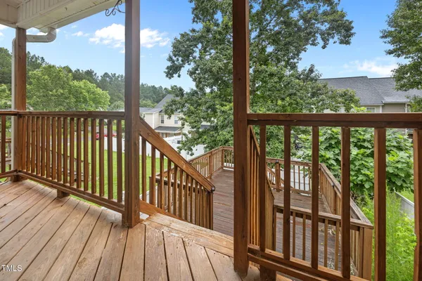 a view of a wooden balcony with outdoor space