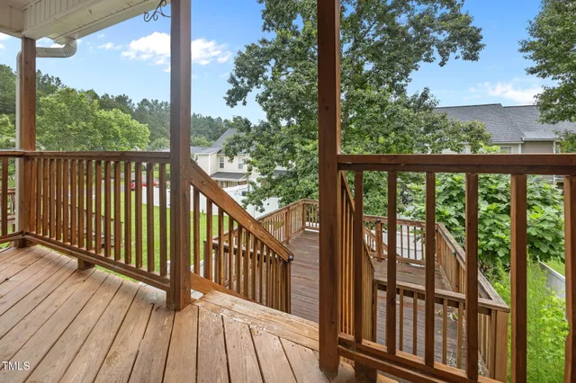 a view of a wooden balcony with outdoor space