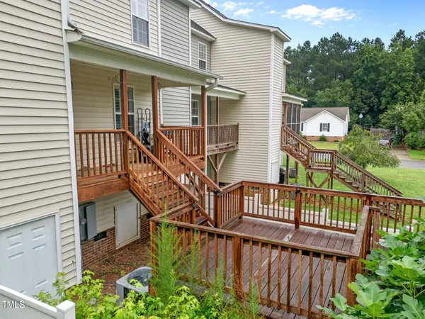 a view of a wooden house with a small deck