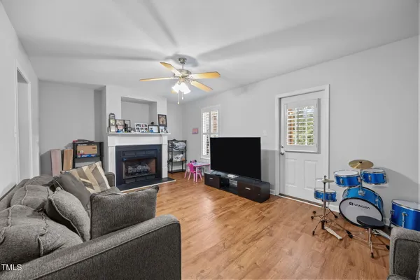 a living room with furniture a fireplace and a flat screen tv