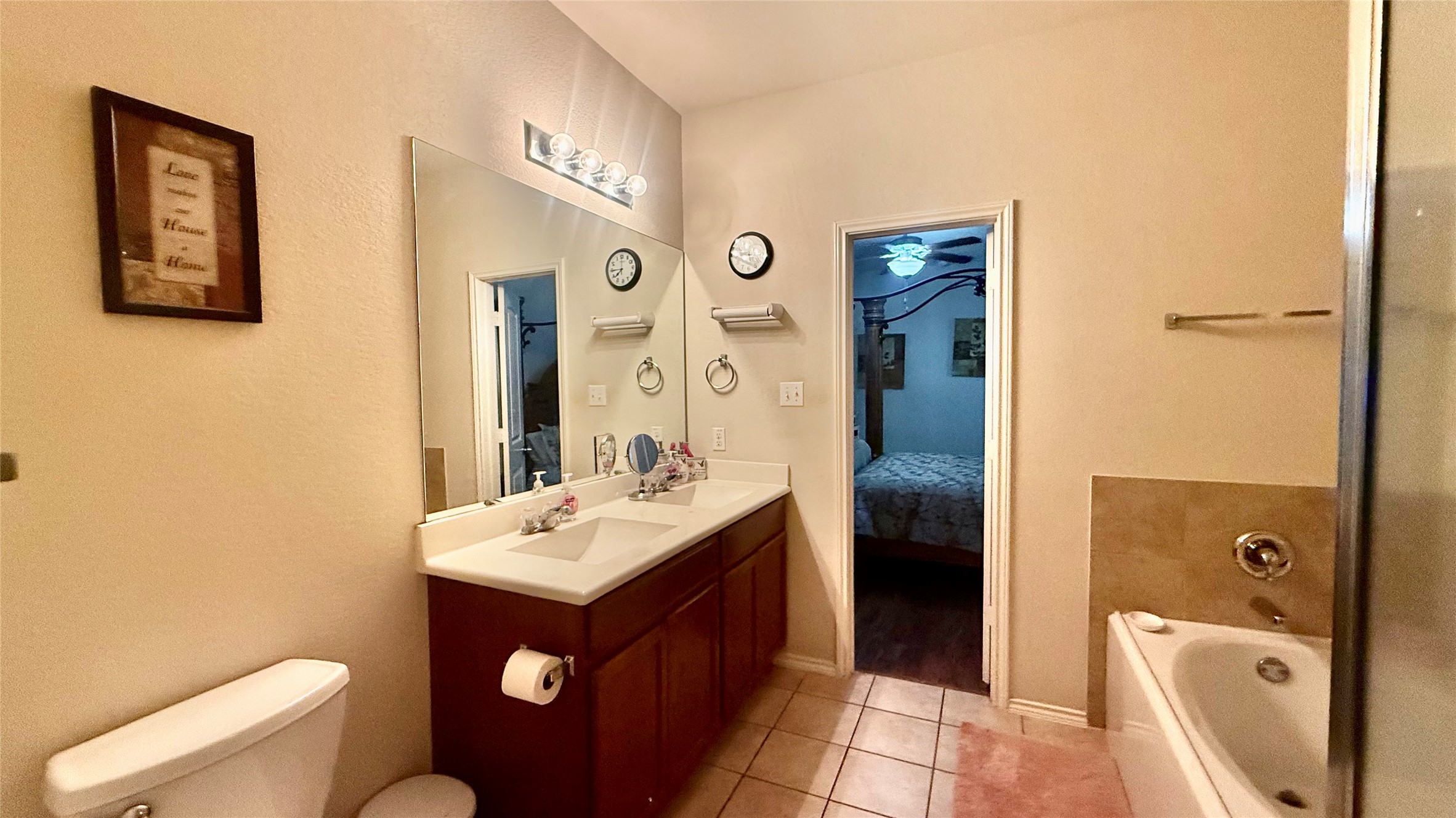 18309 Wind Tree Lane Elgin, TX 78621 - Photo 15 of 29 A classic master bathroom features a double vanity and tile flooring.