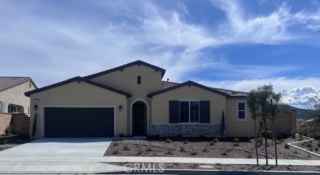 24261 Arroyo Drive Menifee, CA 92584 - Photo 1 of 24 a front view of a house with a garden