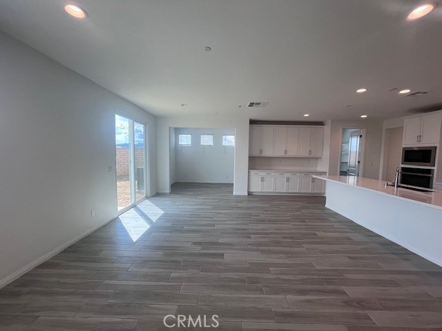 24261 Arroyo Drive Menifee, CA 92584 - Photo 13 of 24 a view of kitchen with stove and wooden floor