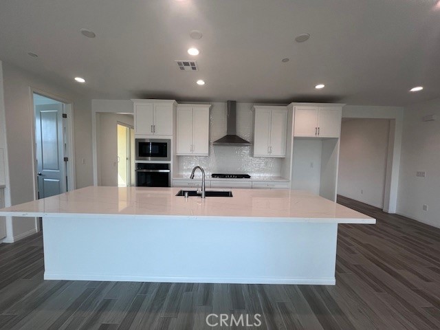 24261 Arroyo Drive Menifee, CA 92584 - Photo 14 of 24 a large kitchen with stainless steel appliances a large counter top