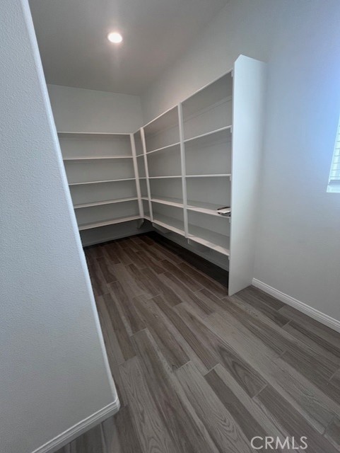 24261 Arroyo Drive Menifee, CA 92584 - Photo 16 of 24 a view of a room with wooden floor and brick wall