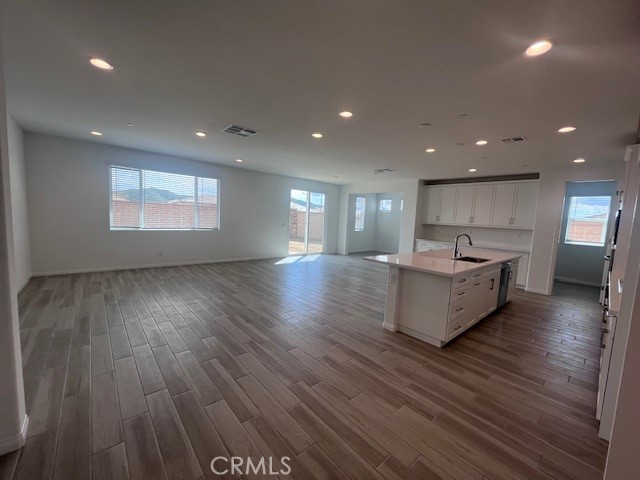 24261 Arroyo Drive Menifee, CA 92584 - Photo 10 of 24 a large kitchen with stainless steel appliances granite countertop a large counter top a wooden floors and a large window
