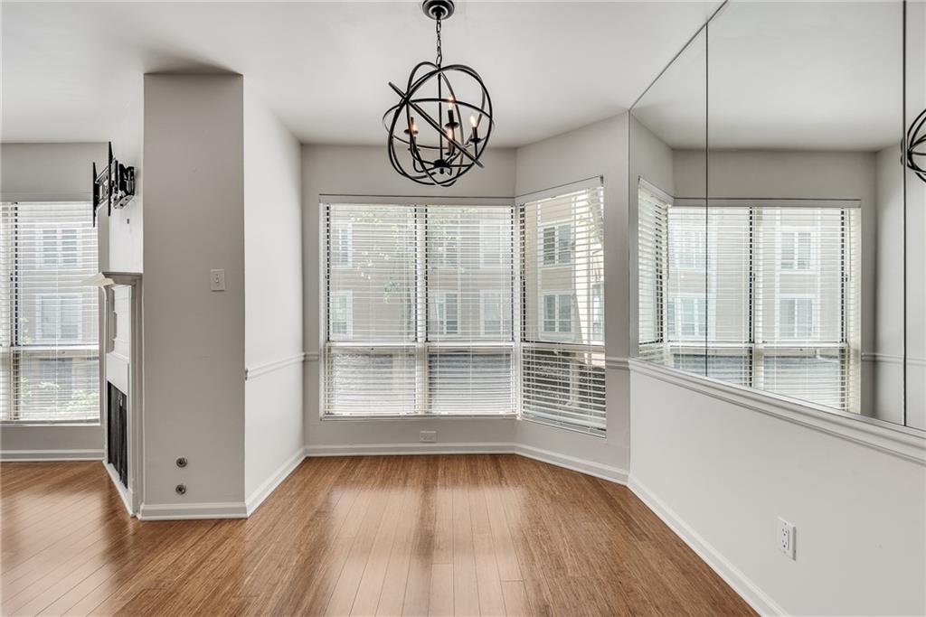 244 13th Street Northeast, Unit 118 Atlanta, GA 30309 - Photo 15 of 48 a view of an empty room with wooden floor and a window